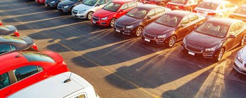 Dealer New Cars Stock. Colorful Brand New Compact Vehicles For Sale Awaiting on the Dealer Parking Lot. Car Market Business Concept.